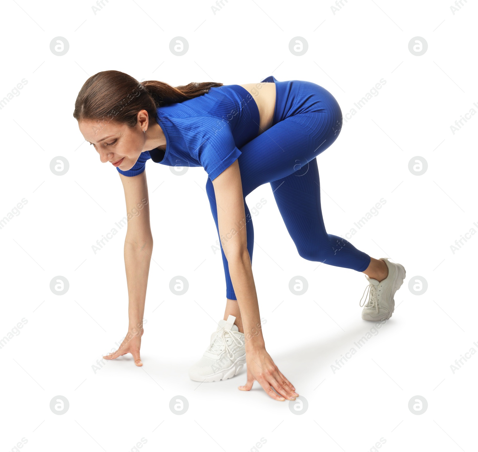 Runner in starting position on white background Photo of Runner in starting position on white background
