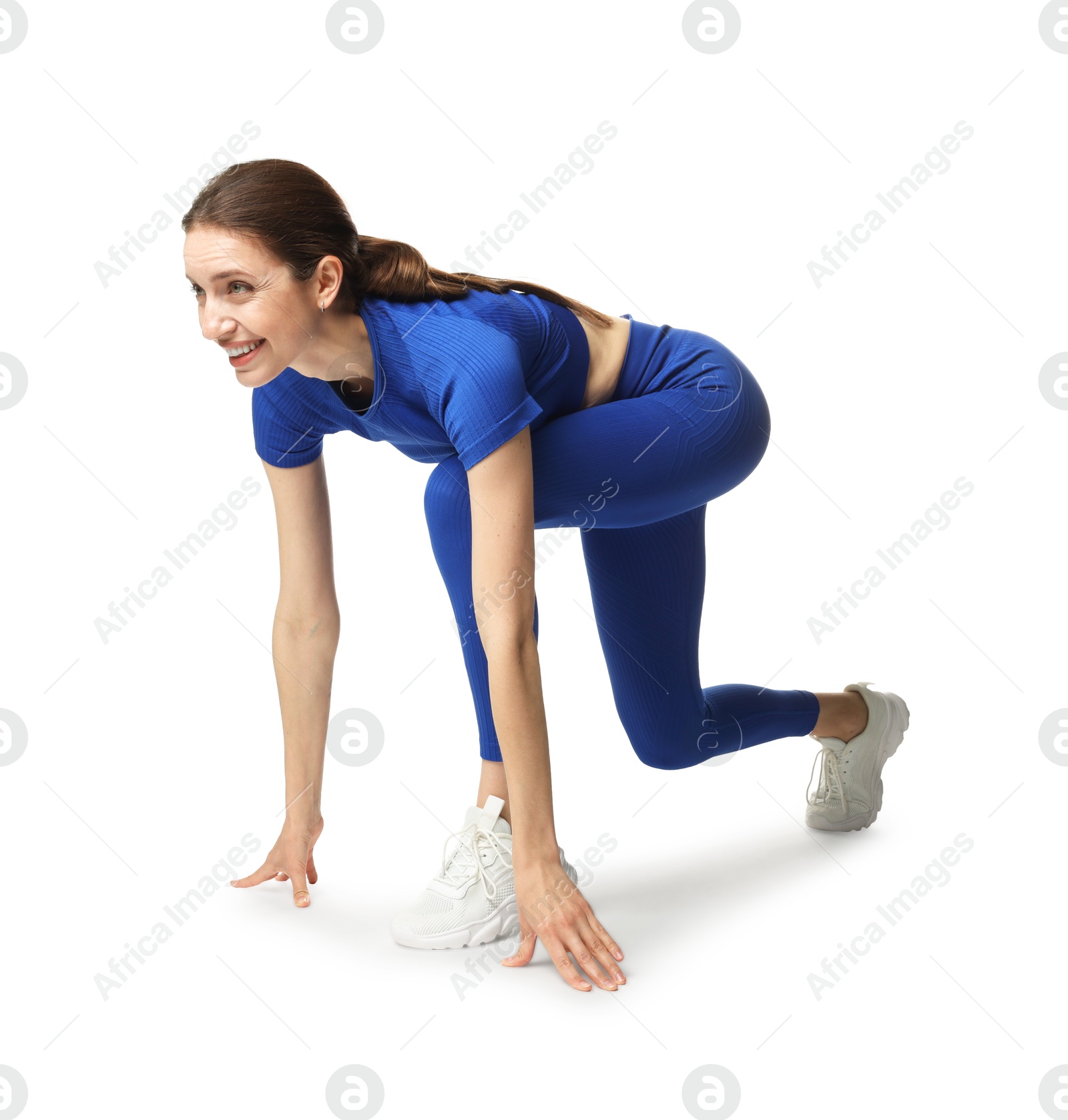 Runner in starting position on white background Photo of Runner in starting position on white background