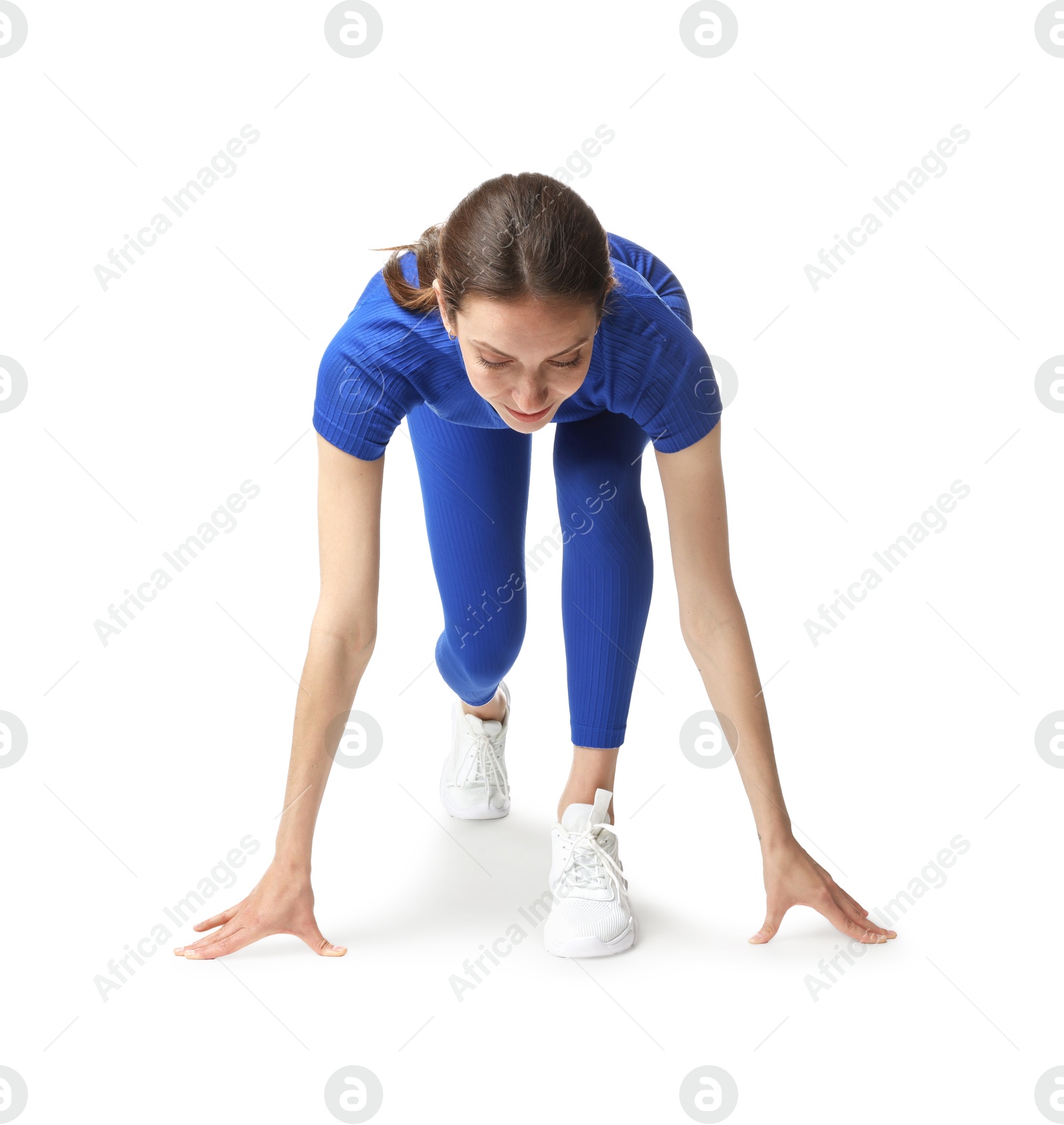 Runner in starting position on white background Photo of Runner in starting position on white background