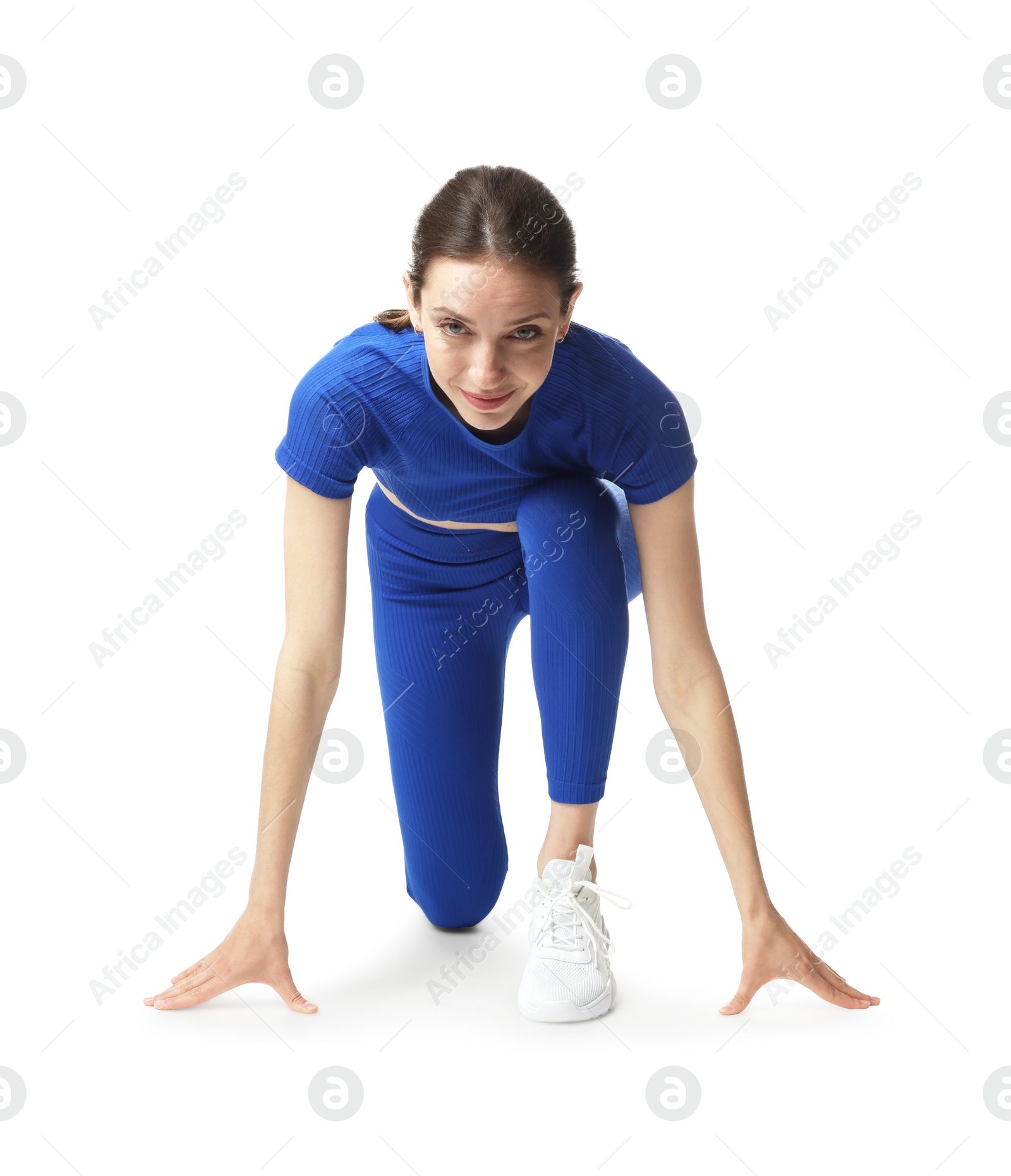 Runner in starting position on white background Photo of Runner in starting position on white background