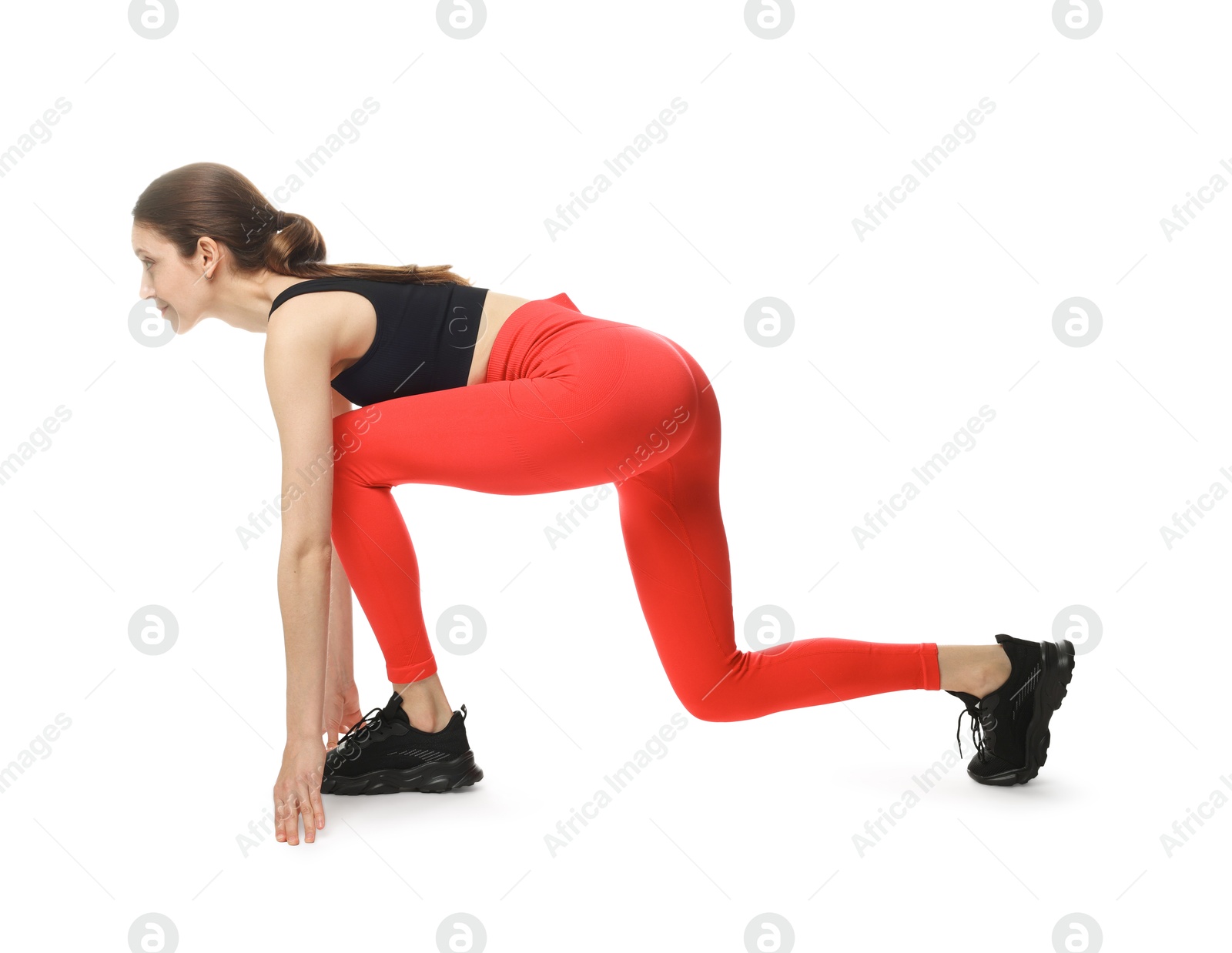 Runner in starting position on white background Photo of Runner in starting position on white background