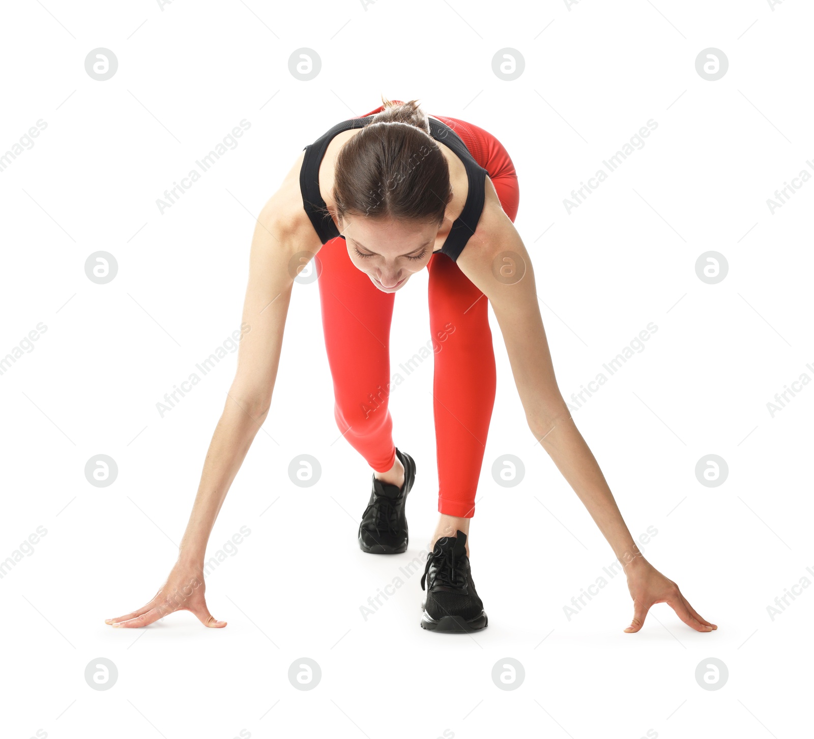 Runner in starting position on white background Photo of Runner in starting position on white background