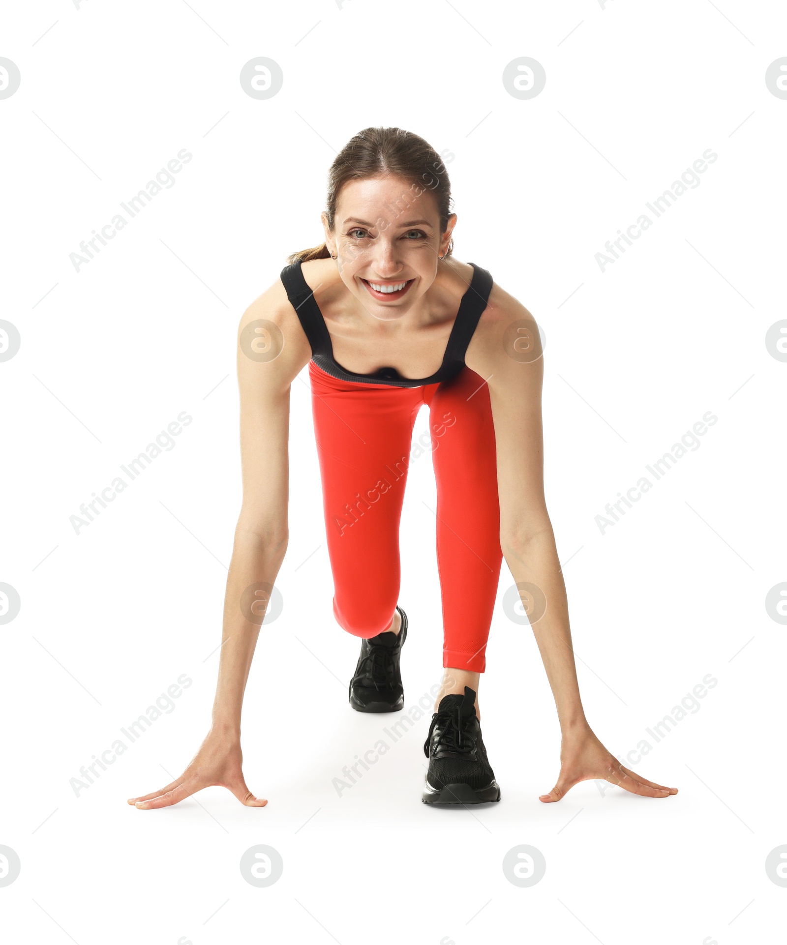 Runner in starting position on white background Photo of Runner in starting position on white background