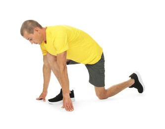 Photo of Runner in starting position on white background