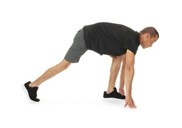 Photo of Runner in starting position on white background