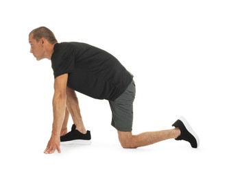 Photo of Runner in starting position on white background