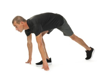 Photo of Runner in starting position on white background