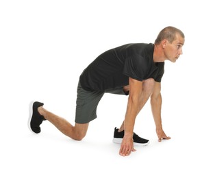 Photo of Runner in starting position on white background