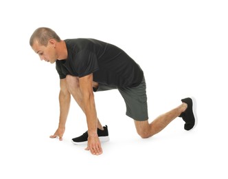 Photo of Runner in starting position on white background