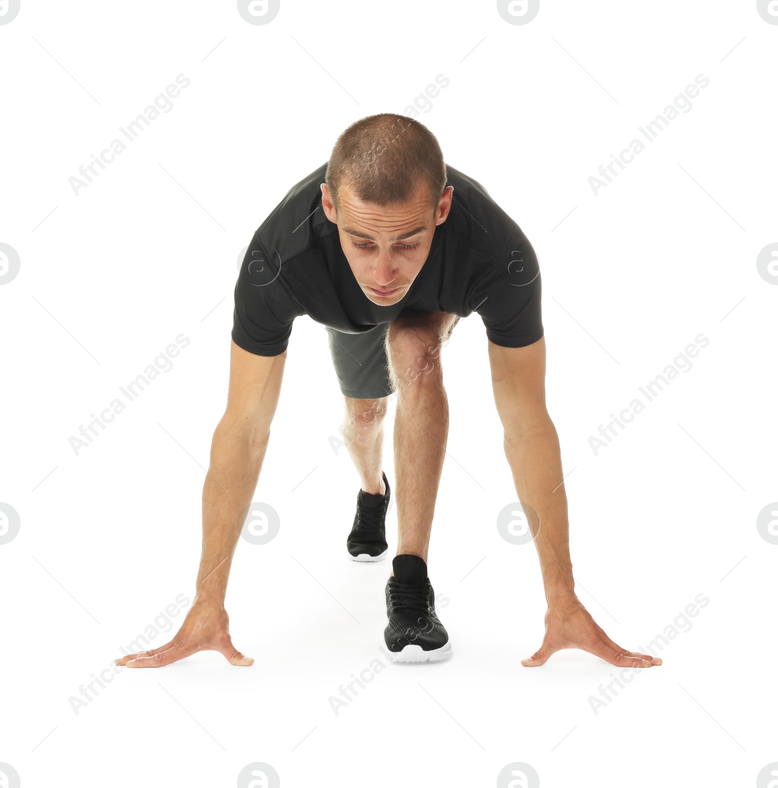 Runner in starting position on white background Photo of Runner in starting position on white background