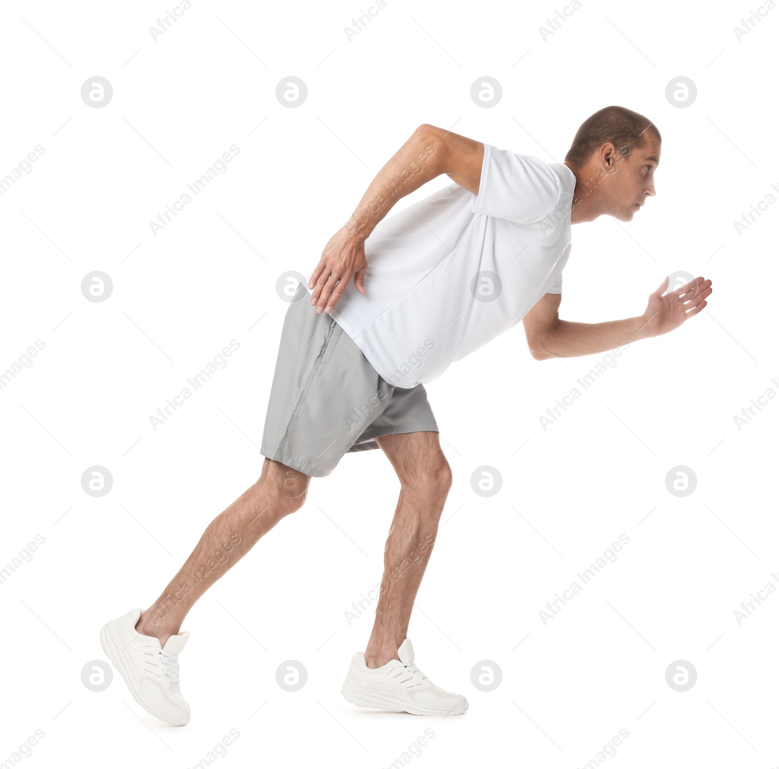 Man in sportswear running on white background Photo of Man in sportswear running on white background