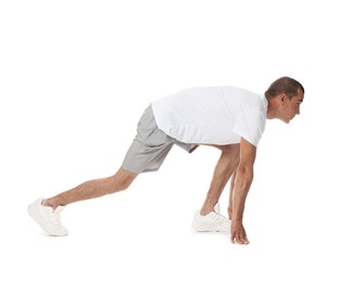 Photo of Runner in starting position on white background