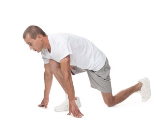 Photo of Runner in starting position on white background