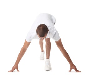 Photo of Runner in starting position on white background