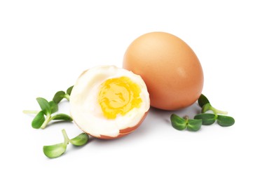 Photo of Soft boiled eggs with microgreens on white background