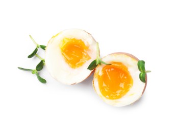 Photo of Soft boiled eggs with microgreens on white background, top view