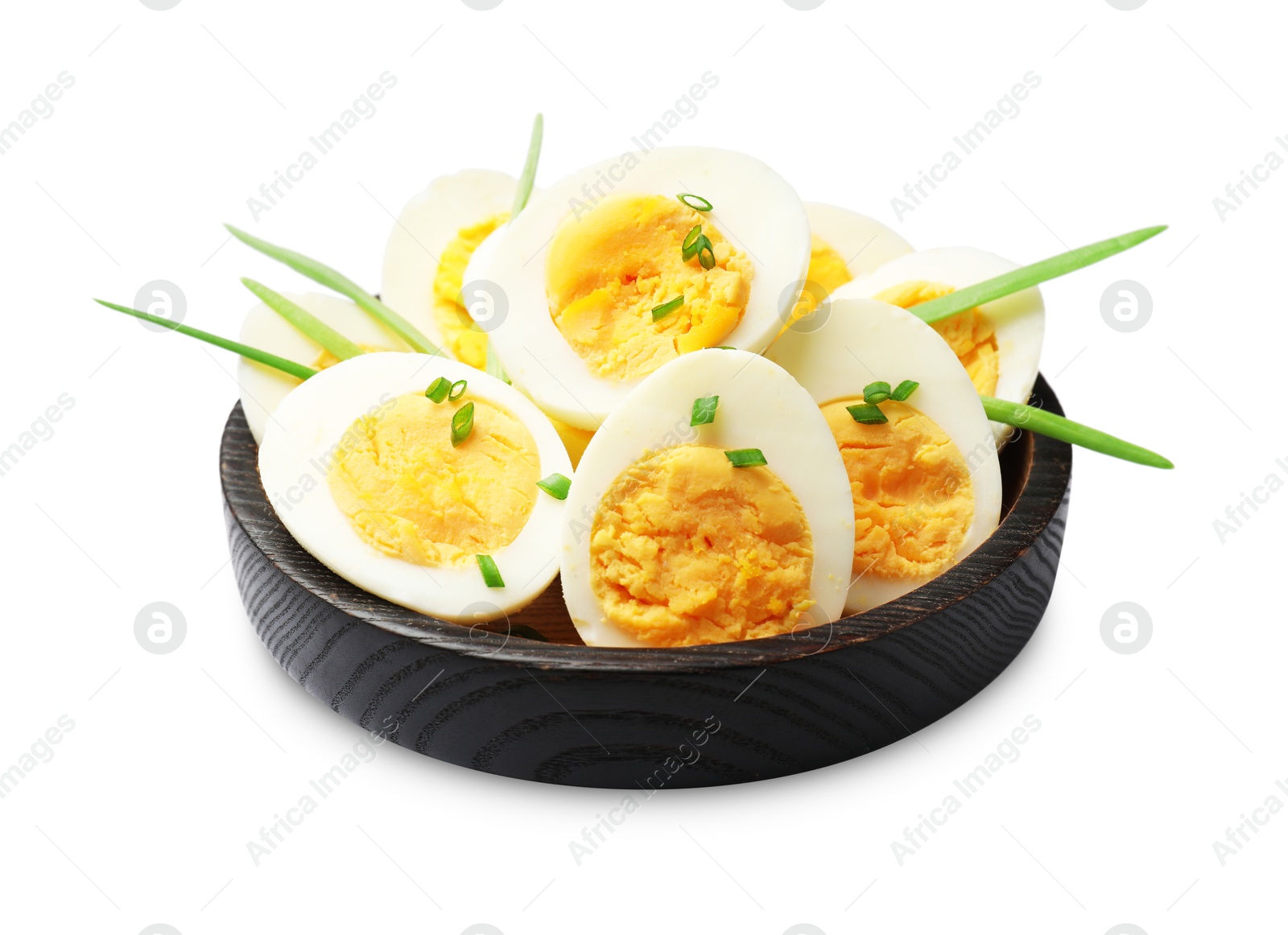 Halves of hard boiled eggs with green onions isolated on white Photo of Halves of hard boiled eggs with green onions isolated on white