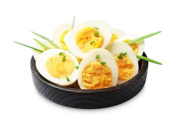 Photo of Halves of hard boiled eggs with green onions isolated on white