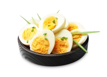 Photo of Halves of hard boiled eggs with green onions isolated on white