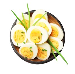 Photo of Halves of hard boiled eggs with green onions isolated on white, top view