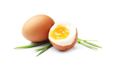 Photo of Soft boiled eggs with green onions isolated on white