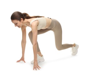 Photo of Runner in starting position on white background