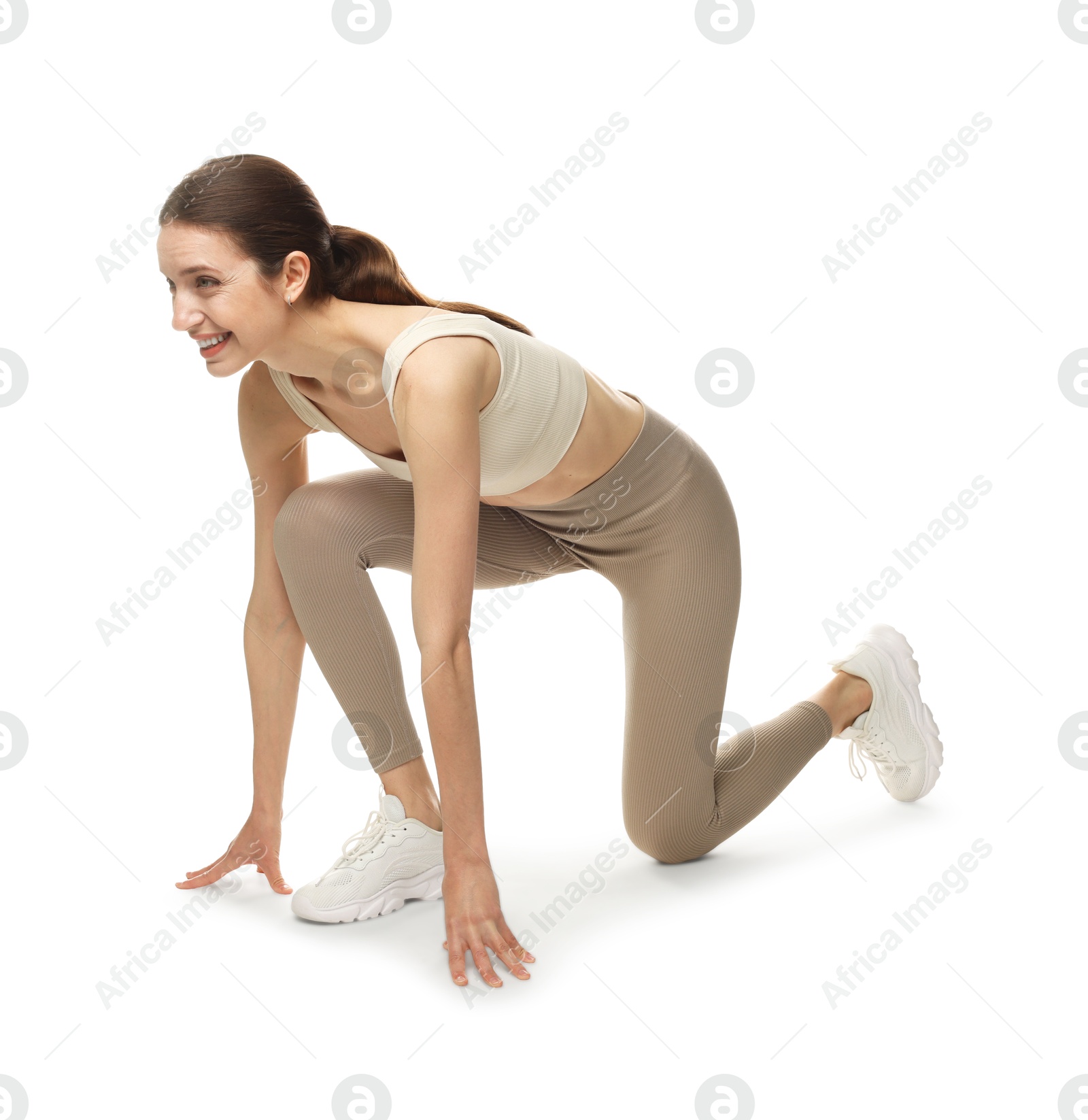 Runner in starting position on white background Photo of Runner in starting position on white background