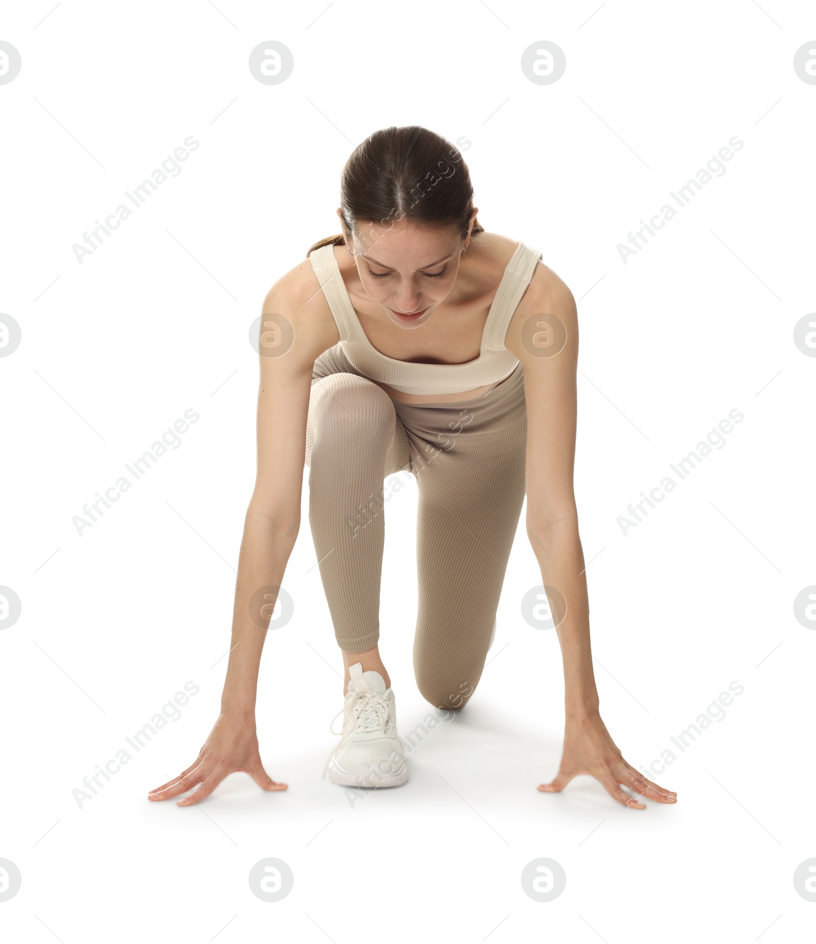 Runner in starting position on white background Photo of Runner in starting position on white background