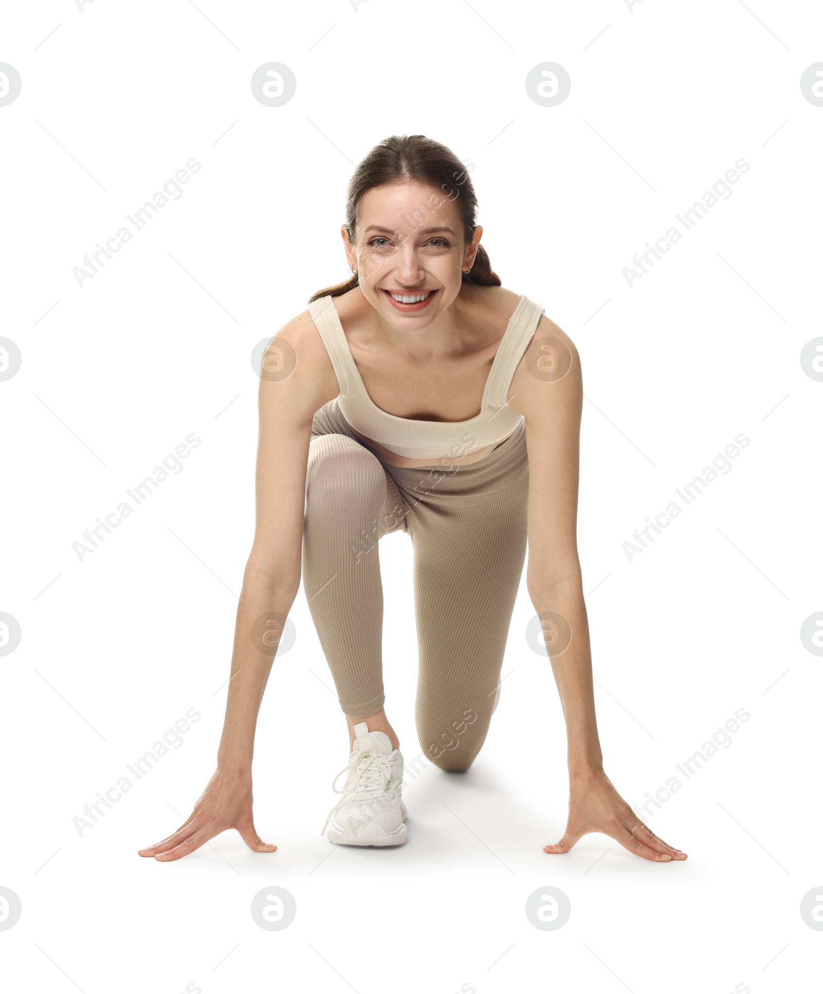 Runner in starting position on white background Photo of Runner in starting position on white background