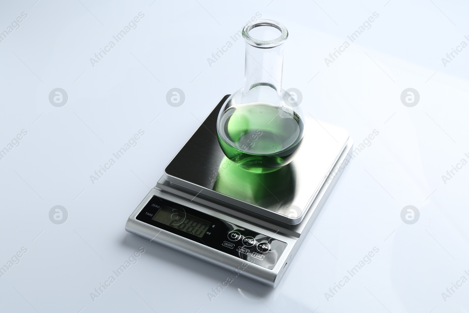 Laboratory scale with flask of sample on white background Photo of Laboratory scale with flask of sample on white background