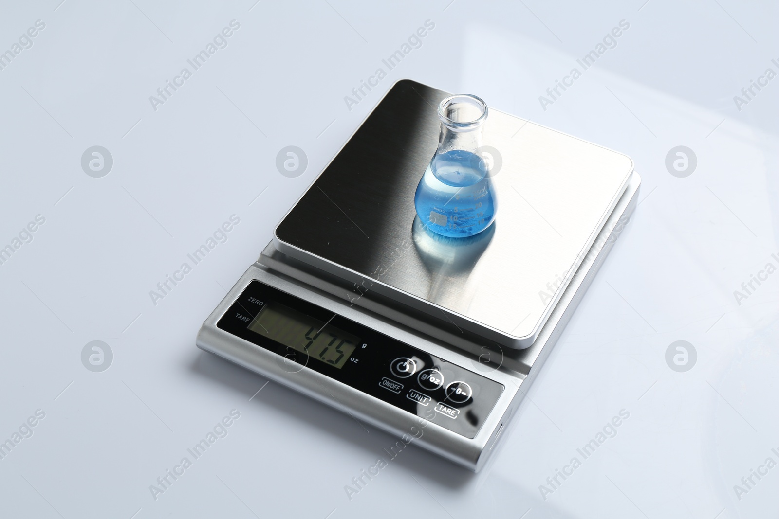 Laboratory scale with flask of sample on white background Photo of Laboratory scale with flask of sample on white background