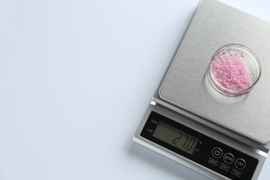 Photo of Laboratory scale with Petri dish of sample on white background, top view. Space for text