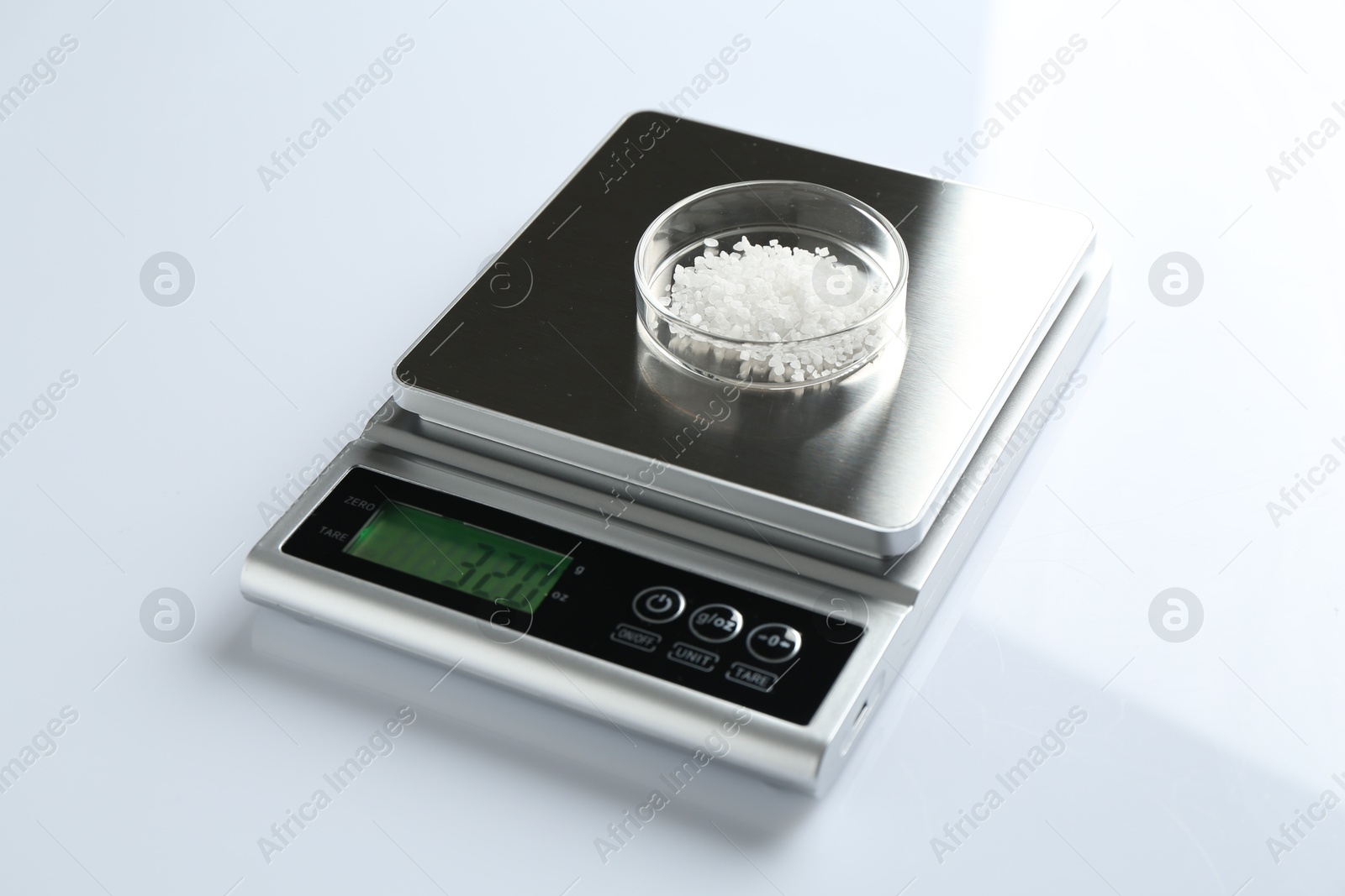 Laboratory scale with Petri dish of sample on white background, closeup Photo of Laboratory scale with Petri dish of sample on white background, closeup