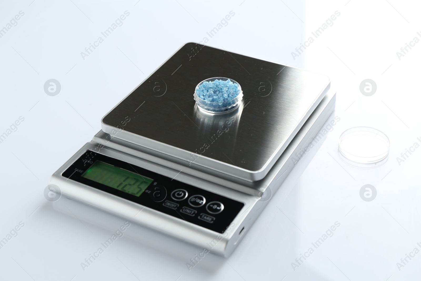 Laboratory scale with Petri dish of sample on white background, closeup Photo of Laboratory scale with Petri dish of sample on white background, closeup