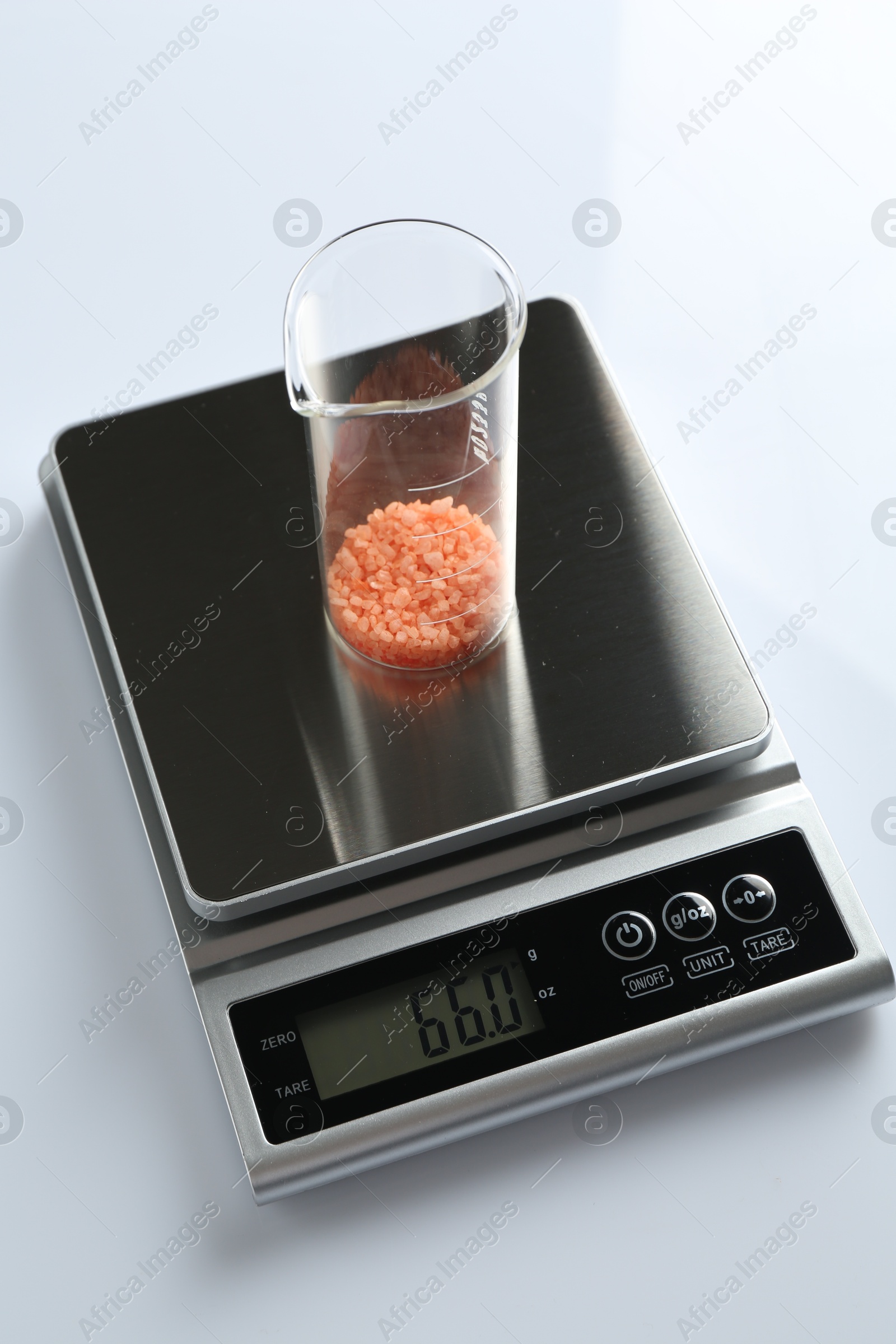 Laboratory scale with beaker of sample on white background, above view Photo of Laboratory scale with beaker of sample on white background, above view