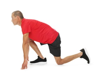 Photo of Runner in starting position on white background