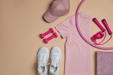 Photo of Sportswear, sports equipment and towel on beige background, flat lay