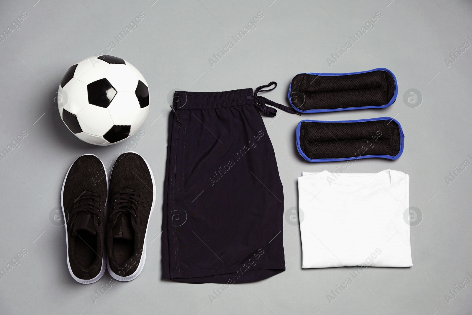 Sportswear, sneakers and soccer ball on grey background, flat lay Photo of Sportswear, sneakers and soccer ball on grey background, flat lay