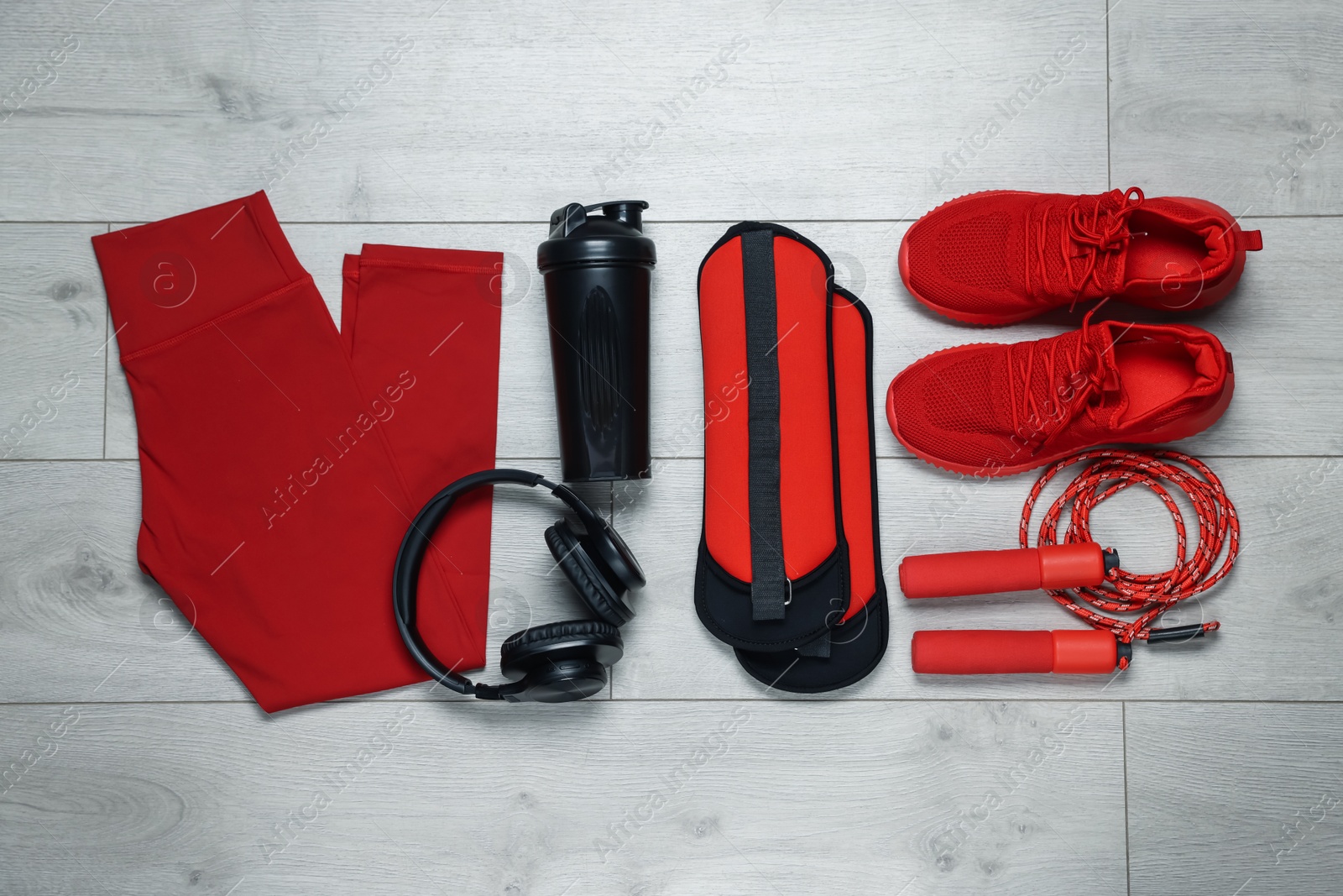 Flat lay composition with sportswear and headphones on floor Photo of Flat lay composition with sportswear and headphones on floor