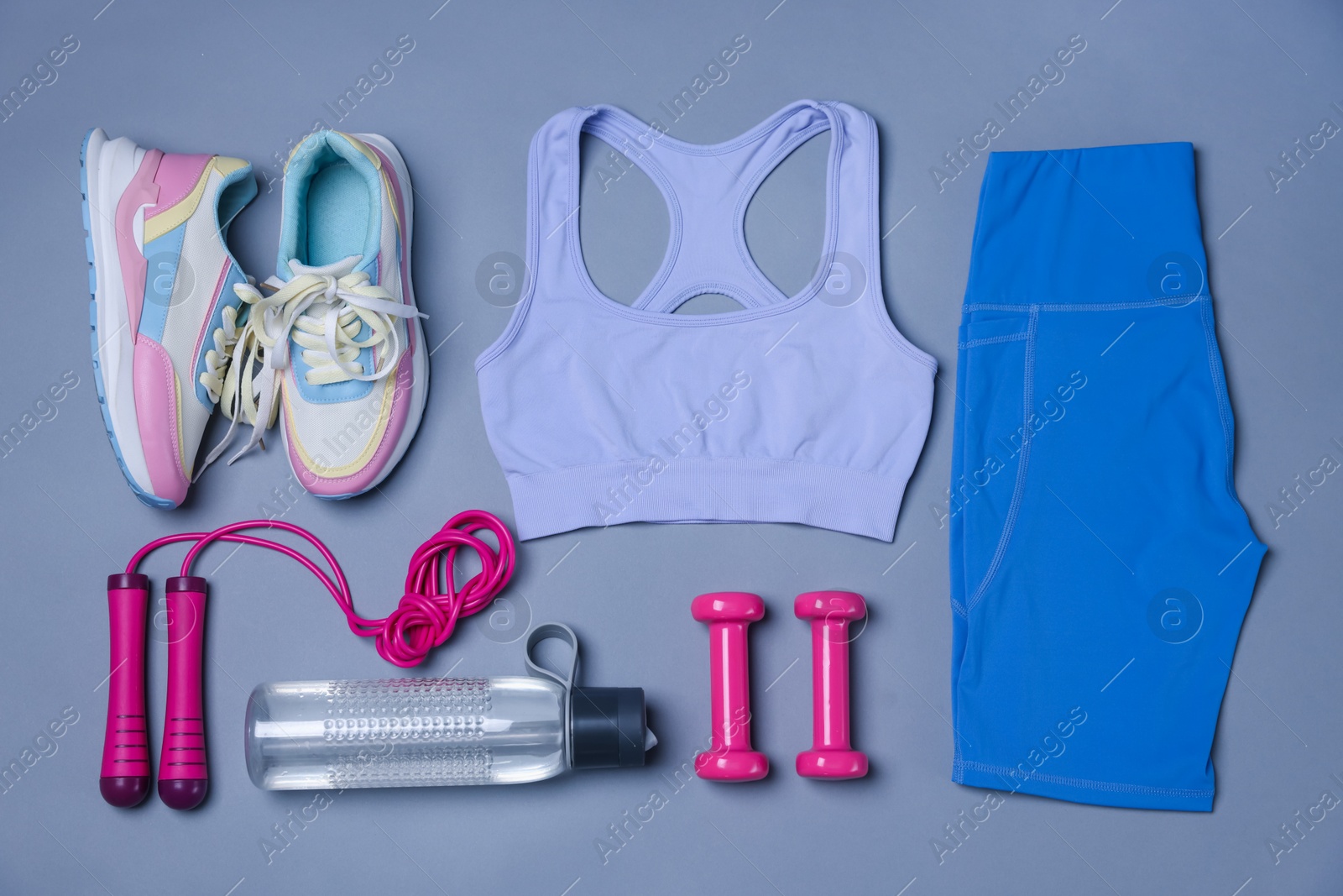 Sportswear, sneakers, skipping rope, dumbbells and water bottle on grey background, flat lay Photo of Sportswear, sneakers, skipping rope, dumbbells and water bottle on grey background, flat lay