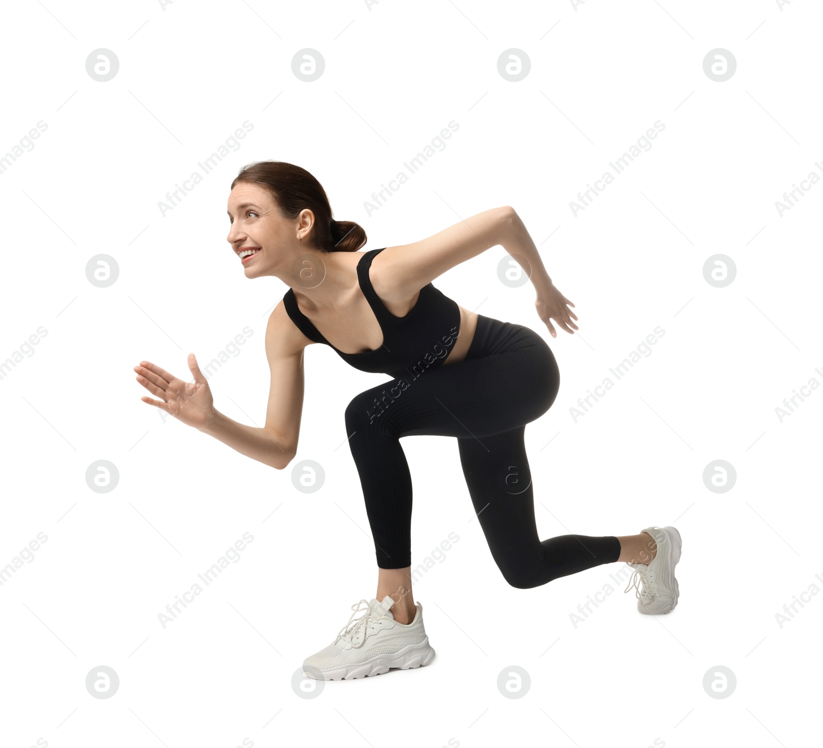 Woman in sportswear running on white background Photo of Woman in sportswear running on white background