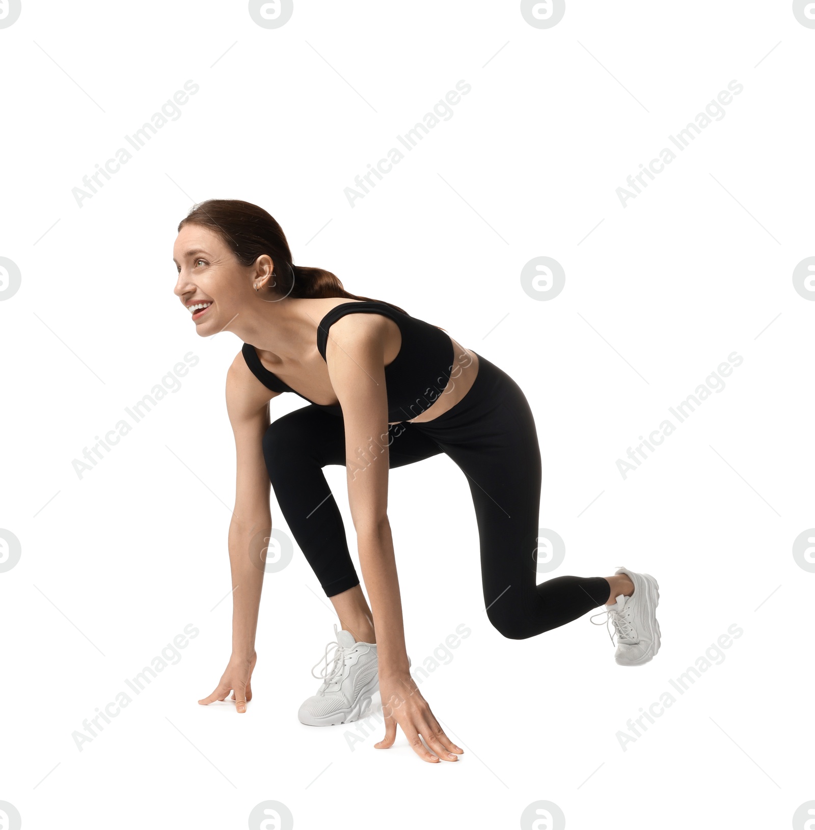 Photo of Runner in starting position on white background
