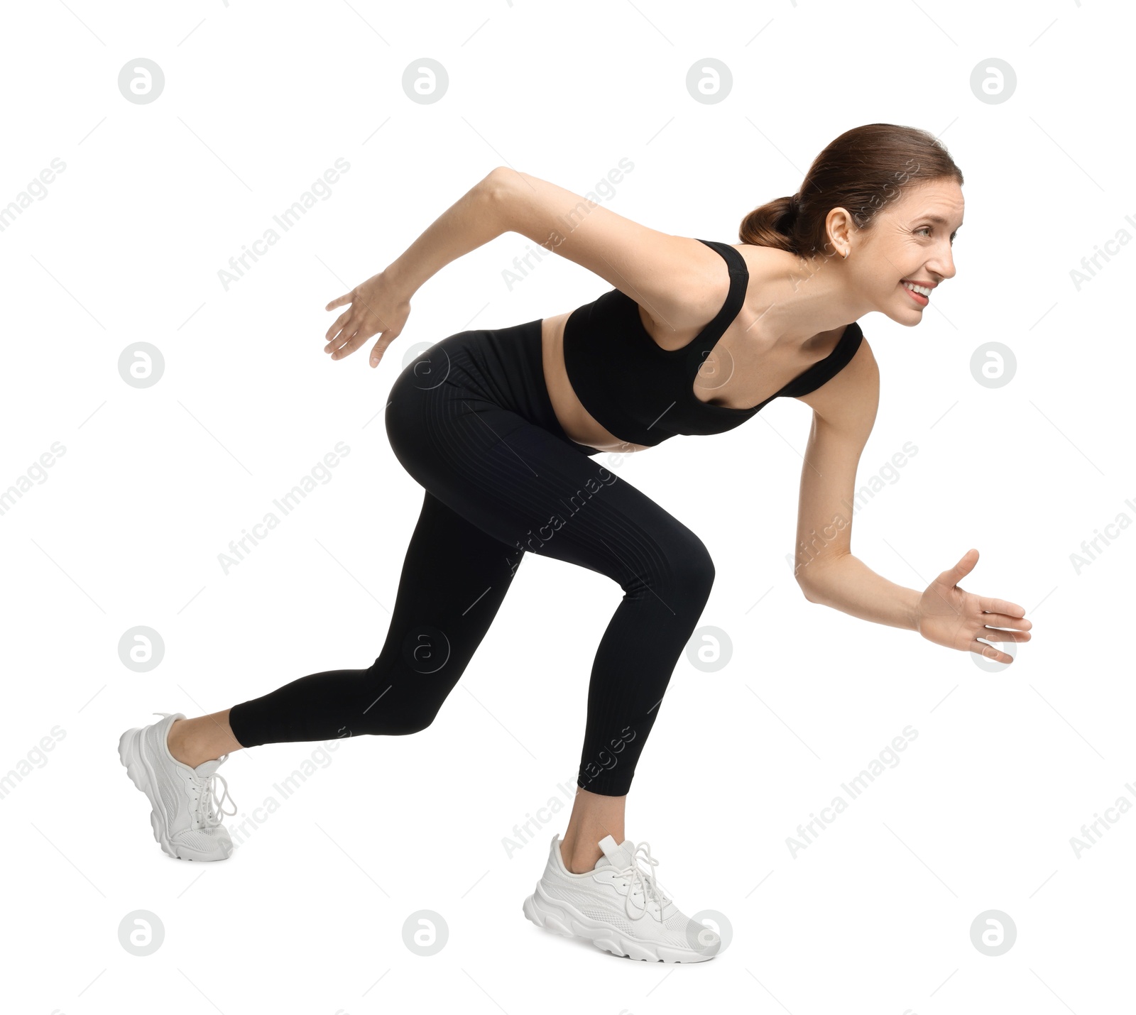 Woman in sportswear running on white background Photo of Woman in sportswear running on white background