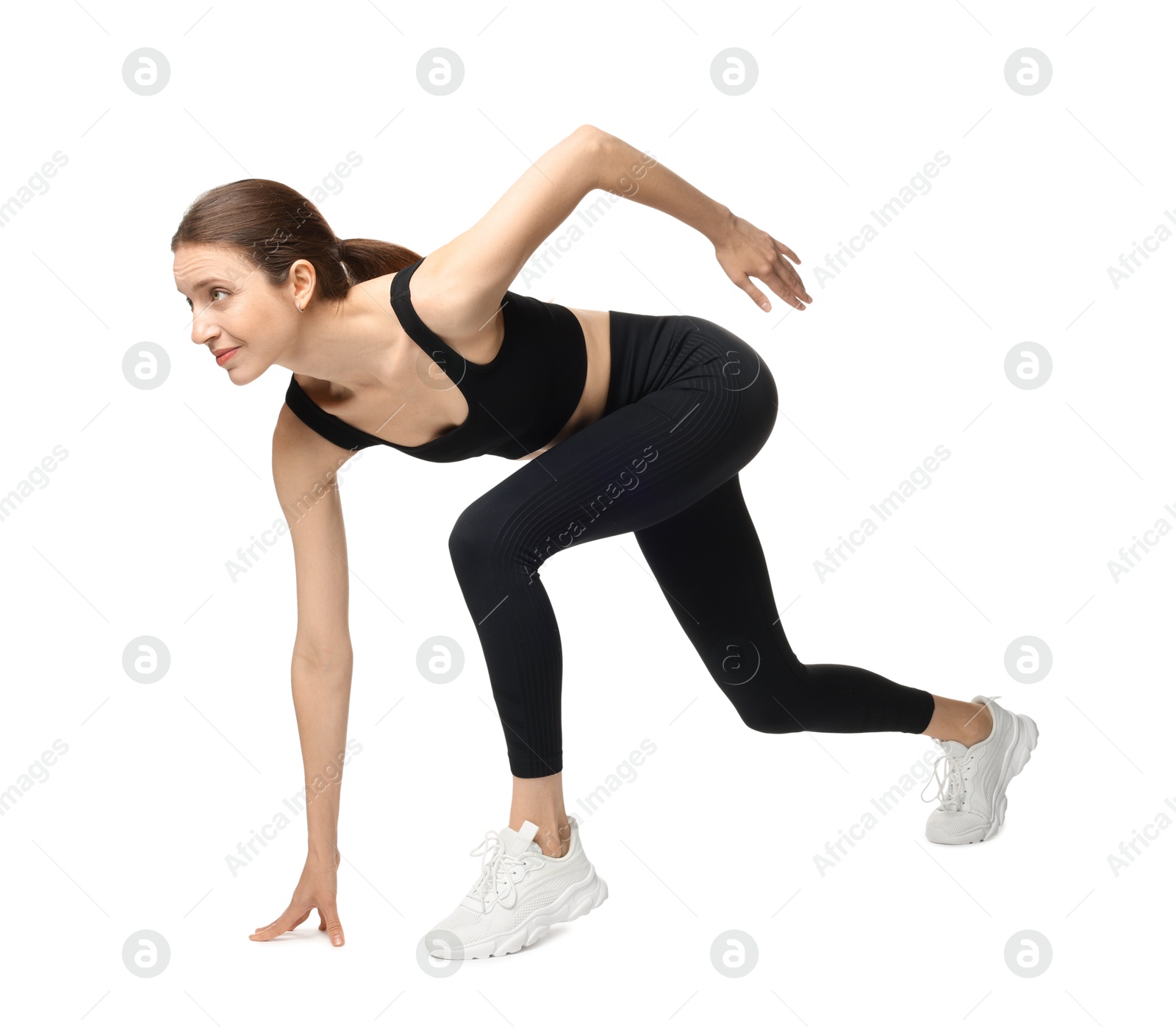 Photo of Runner in starting position on white background