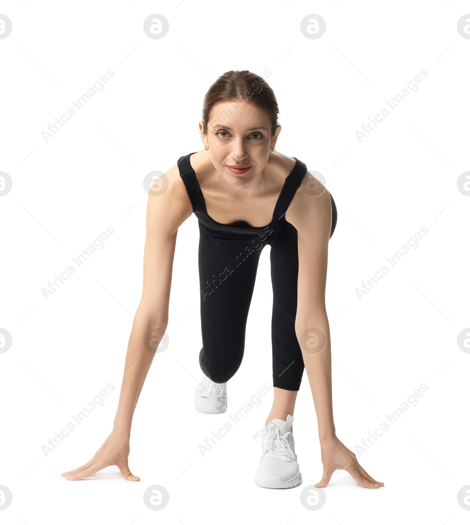 Runner in starting position on white background Photo of Runner in starting position on white background