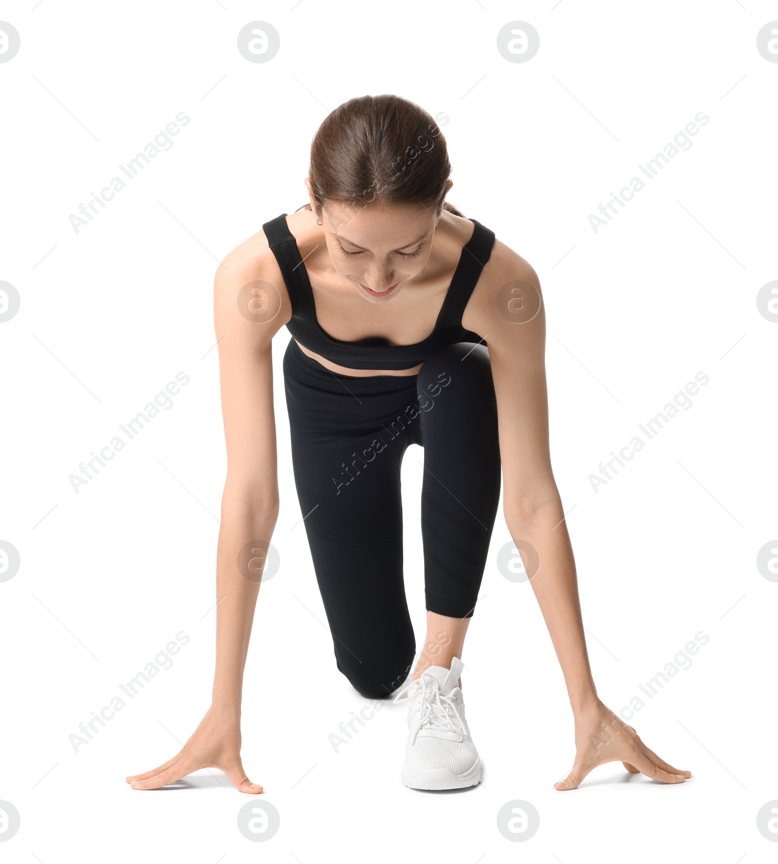 Runner in starting position on white background Photo of Runner in starting position on white background