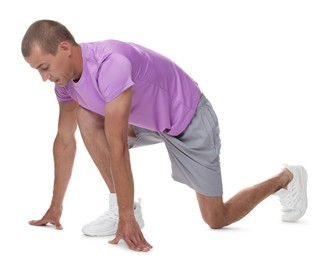 Photo of Runner in starting position on white background