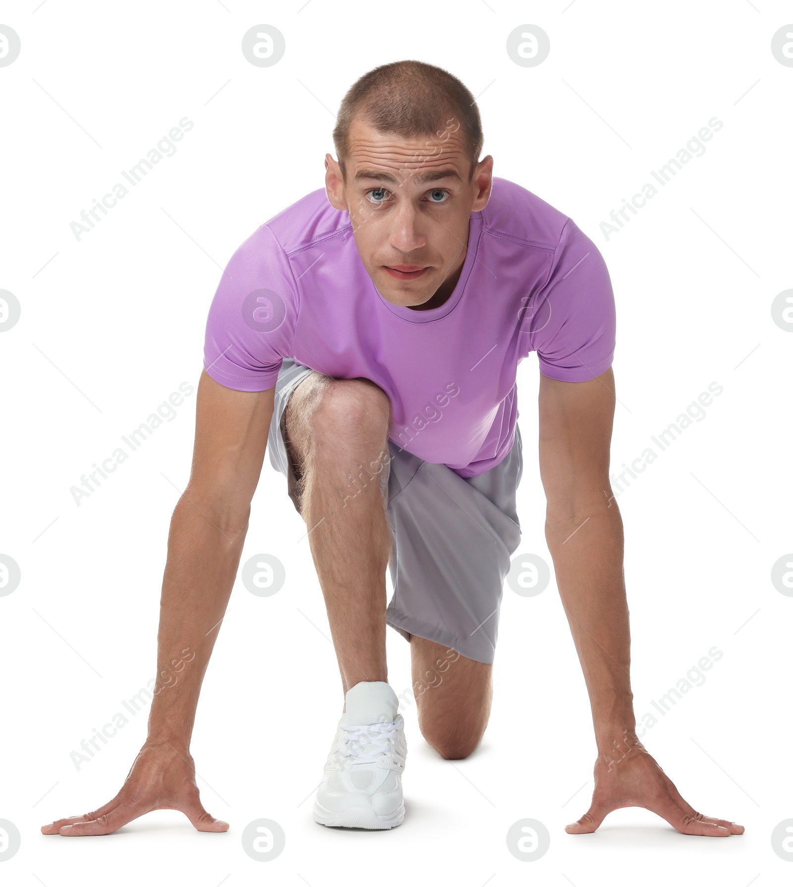 Runner in starting position on white background Photo of Runner in starting position on white background