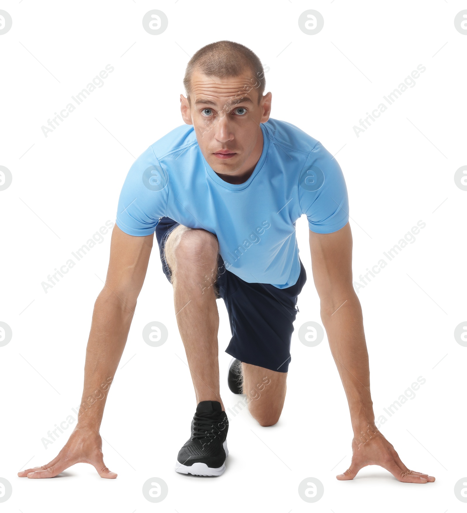 Runner in starting position on white background Photo of Runner in starting position on white background