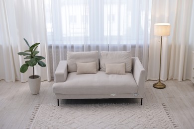 Photo of Stylish living room interior. Sofa, lamp and plant indoors